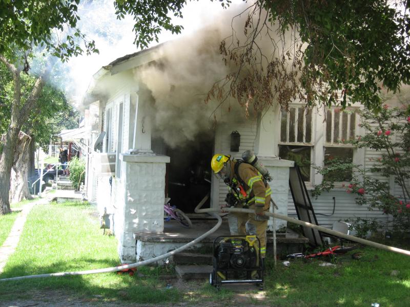 Firefighters conduct a search and extinguish a fire 